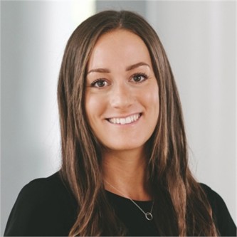 Emma Newstead in a black top, in front of a grey background