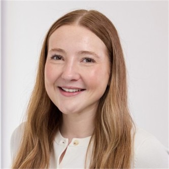 Katie Johnston in a white top, in front of a pale background