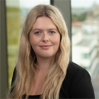 Emma Fosh in a black top, in front of a window