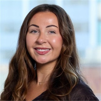 Isobel Pye in a black top, in front of a window
