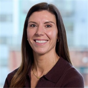 Danielle Ingham in a brown top, in front of a window