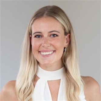 Arabella Hayward in a white top, in front of a grey background