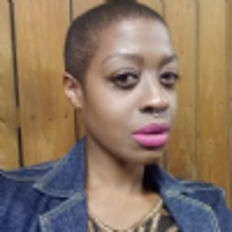 Sonia Watson-Fowler in front of a wooden background.