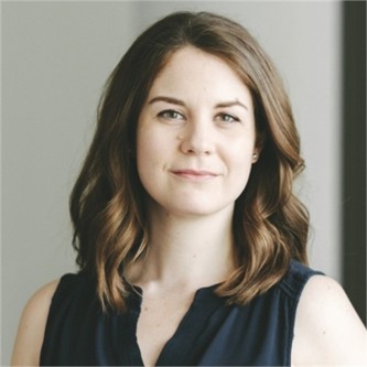 Deborah Gunn in a dark top, in front of a grey background