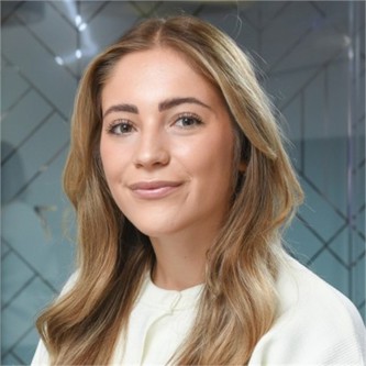 Issue Huckin in a cream top, in front of a geometric glass background