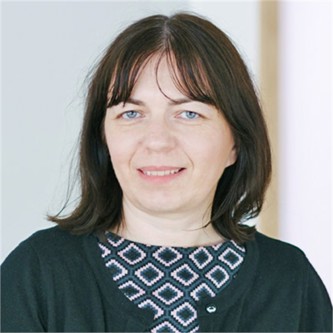 Claire Hunt in a black geometric top, in front of a pale background