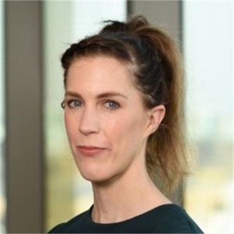 Carrie March in a black top, in front of a window