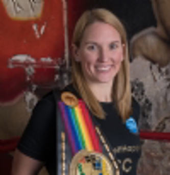 Boxer Stacey Copeland in a black t-shirt holding a boxing belt.